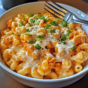 Served bowl of high protein buffalo chicken mac and cheese with ranch and green onion