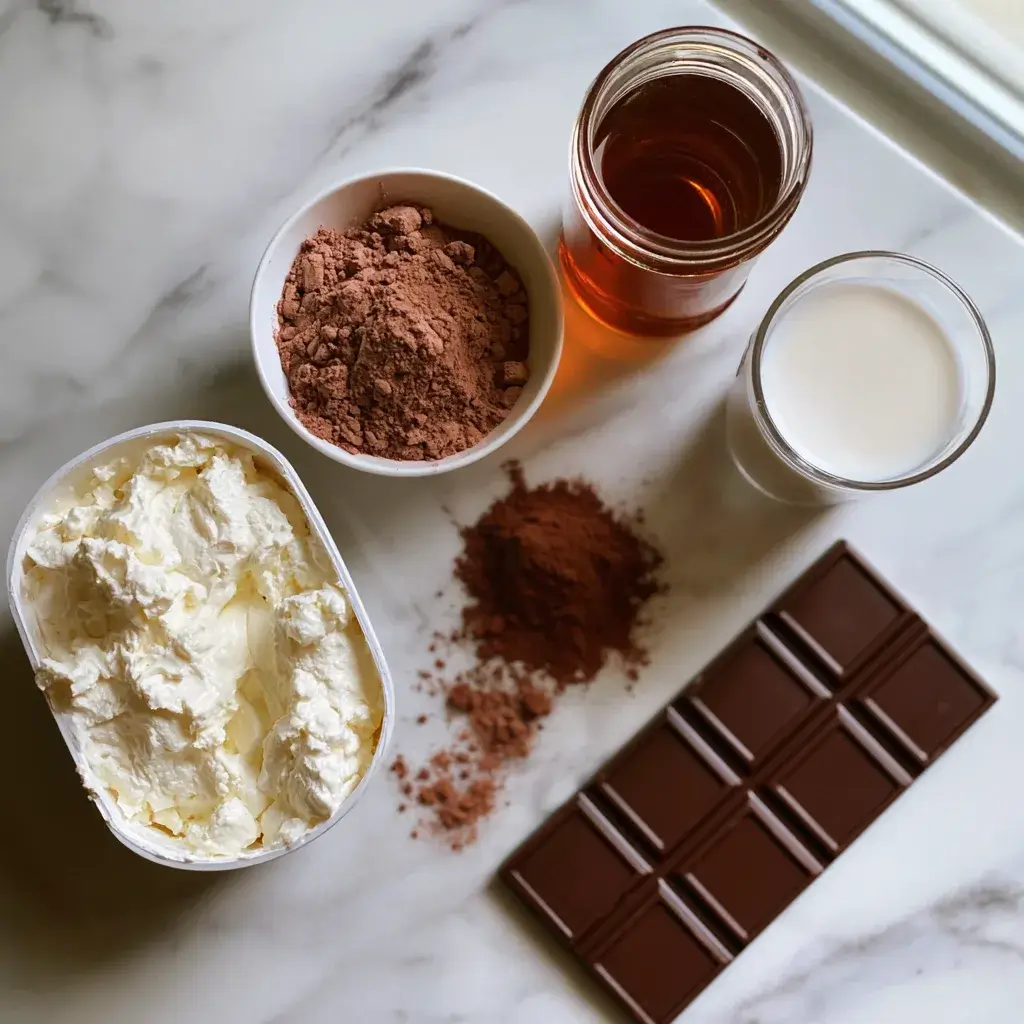 Ingredients for high protein chocolate mousse including cottage cheese, chocolate protein powder, cocoa, maple syrup, and dark chocolate