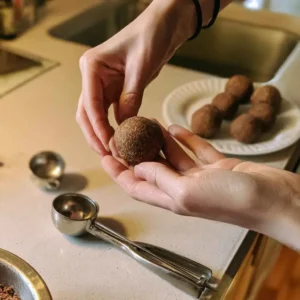 Rolling no-bake dough into balls by hand for a high protein balls recipe