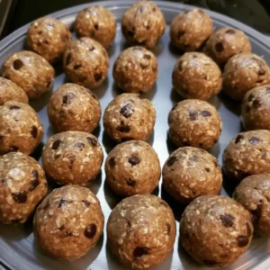 No-bake high protein balls chilling in a single layer on a plate before storing