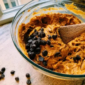 Dark chocolate chips folded into pumpkin batter for high protein pumpkin muffins